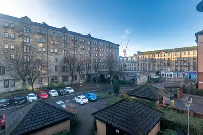 a view of a parking lot in front of a building at ** Modern Merchant City 1 BED Apartment with Free Parking ** in Glasgow