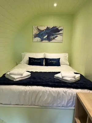 a bedroom with a large bed in a room at Patie's Hill in Penicuik