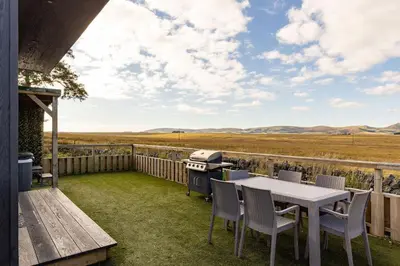 a patio with a table and chairs and a grill at East Kip - Dog Friendly in Penicuik