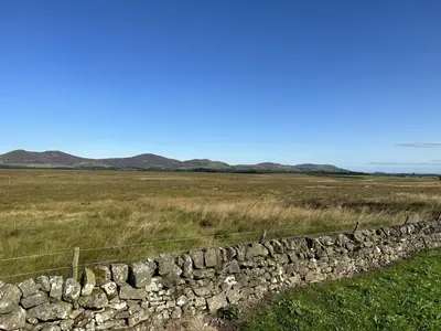 a stone wall in the middle of a field at East Kip - Dog Friendly in Penicuik