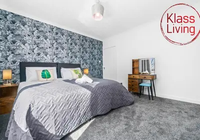 a bedroom with a large bed and a desk at Coats Street Apartment by Klass Living Coatbridge in Coatbridge