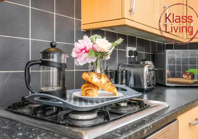 a plate of croissants on a stove in a kitchen at Coats Street Apartment by Klass Living Coatbridge in Coatbridge