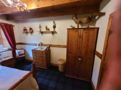 a bedroom with a bed and some figurines on the wall at Baidland Escapes 2 bedroom cottage With hot tub in Dalry