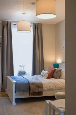 a bedroom with a bed in front of a window at Small Cosy Studio Flat Near the Sea, Central Oban in Oban
