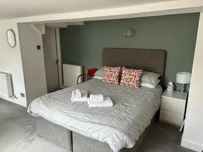 a bedroom with a bed with towels on it at Netherby Guest House Edinburgh in Edinburgh
