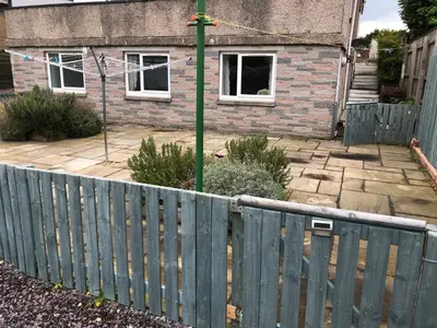 a wooden fence in front of a house at Netherby Guest House Edinburgh in Edinburgh