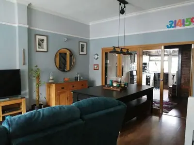 a living room with a couch and a table at Aigas Cottage in Glasgow
