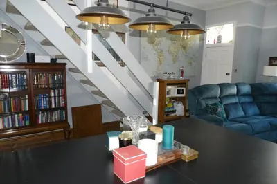 a living room with a table and a blue couch at Aigas Cottage in Glasgow