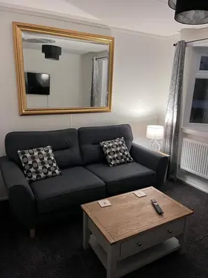 a living room with a couch and a coffee table at Semi-detached chalet at Maryville Caravan Site - Uddingston, Glasgow in Uddingston
