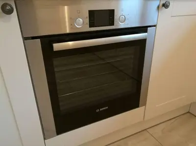 a stainless steel oven with a microwave on top at Historic cottage next to loch lomond Luss in Alexandria