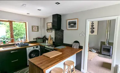 a kitchen with a counter and a stove top oven at Eakie House Apartments - Kinlochleven in Kinlochleven