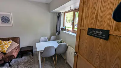 a room with a table and chairs and a window at Eakie House Apartments - Kinlochleven in Kinlochleven