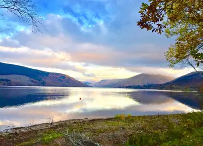 a view of a lake with mountains in the background at Seal Cove Cabin - Luxury Glamping in Cairndow