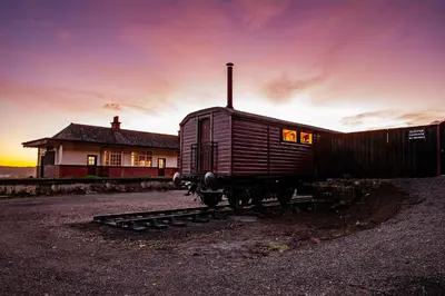 an old train car sitting in front of a house at The Carriage at Creagan in Creagan