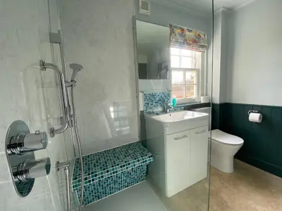 a bathroom with a shower and a sink and a toilet at Private detached cottage sleeps 4 in Crieff