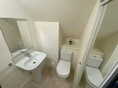 a white bathroom with a toilet and a sink at Private detached cottage sleeps 4 in Crieff