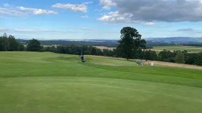 a golfer is on the green of a golf course at Private detached cottage sleeps 4 in Crieff