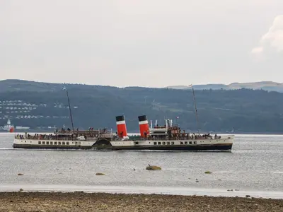 a large boat in the water with people on it at Mars Hill Lower in Dunoon