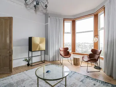 a living room with a glass table and chairs at Mars Hill Lower in Dunoon