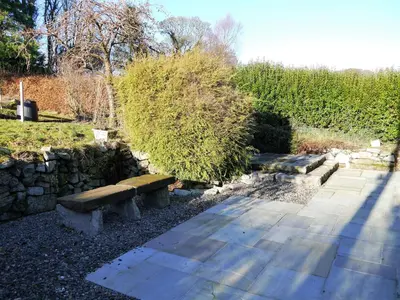 a group of benches sitting in a garden at Skerrow in New Galloway
