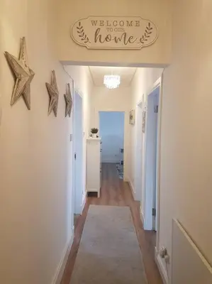 a hallway with a hallway leading to a house at Wee Harbour View in Millport