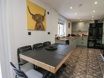a kitchen with a table and some chairs in it at Ben View in Arrochar