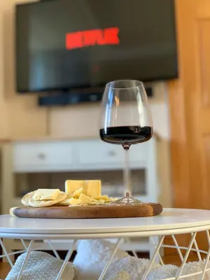 a glass of wine and cheese on a table at Lomond View in Luss