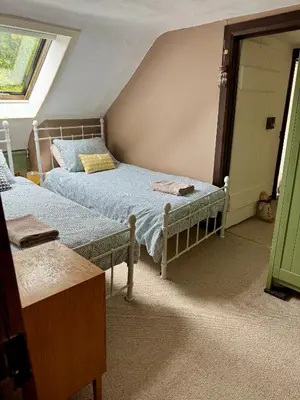 a bedroom with two twin beds and a window at East Cottage at Powis House Estate in Stirling