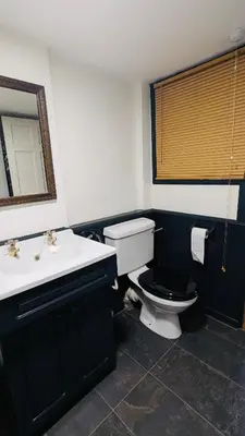 a bathroom with a toilet and a sink and a mirror at East Cottage at Powis House Estate in Stirling