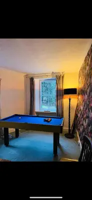 a pool table in a living room with a window at Mid Cottage at Powis House Estate in Stirling