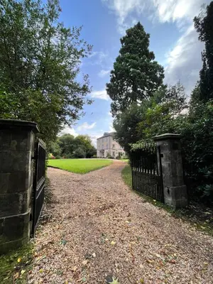 a gate to a garden with a house in the background at Mid Cottage at Powis House Estate in Stirling