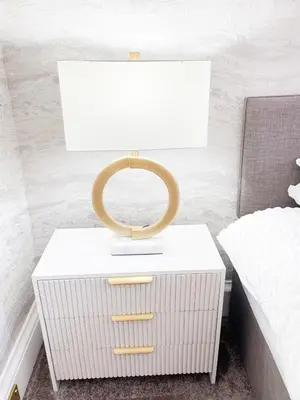 a white nightstand with a ring on it next to a bed at Kenavara House in Oban