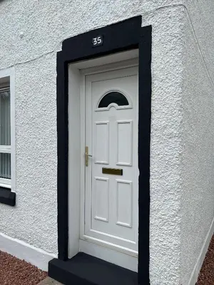 a white door with a black frame around it at Cosy Cottage Apartment in Helensburgh