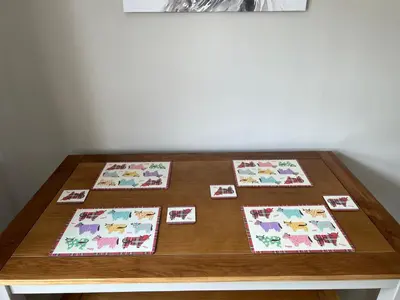 a wooden table with four cards on it at Cosy Cottage Apartment in Helensburgh