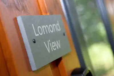 a sign on a door that says london view at Lomond View in Langbank