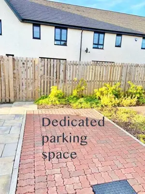 amitted parking space sign in front of a house at 3 bed house with parking near airport in Edinburgh